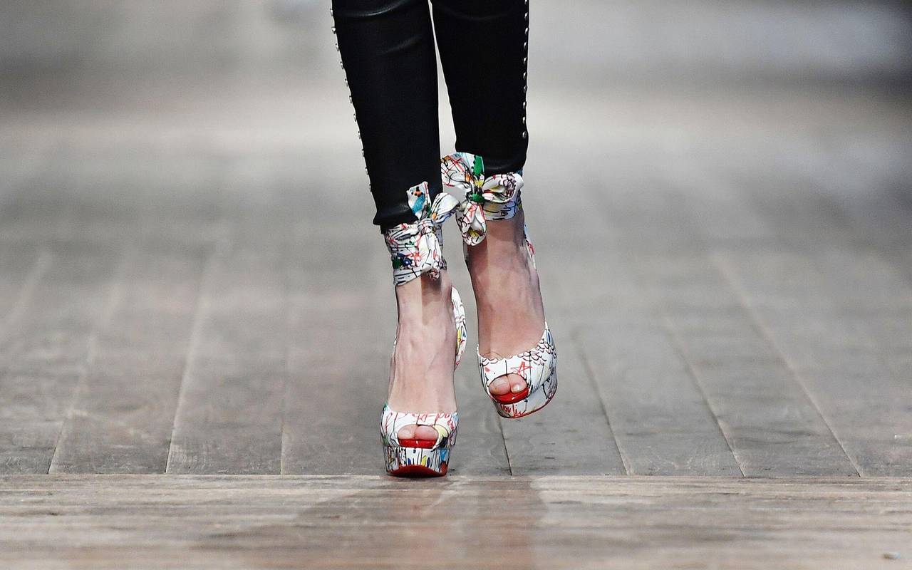 Model läuft in High Heels mit Plateau über den Laufsteg