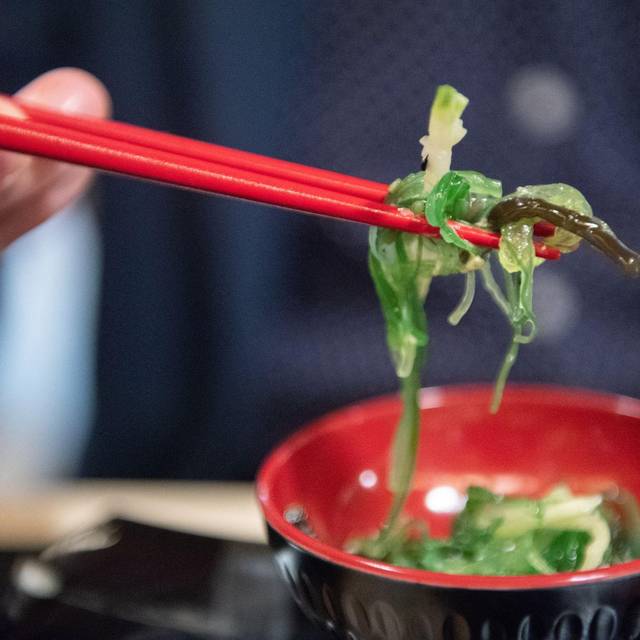 Ein Mann isst einen Wakame-Algensalat