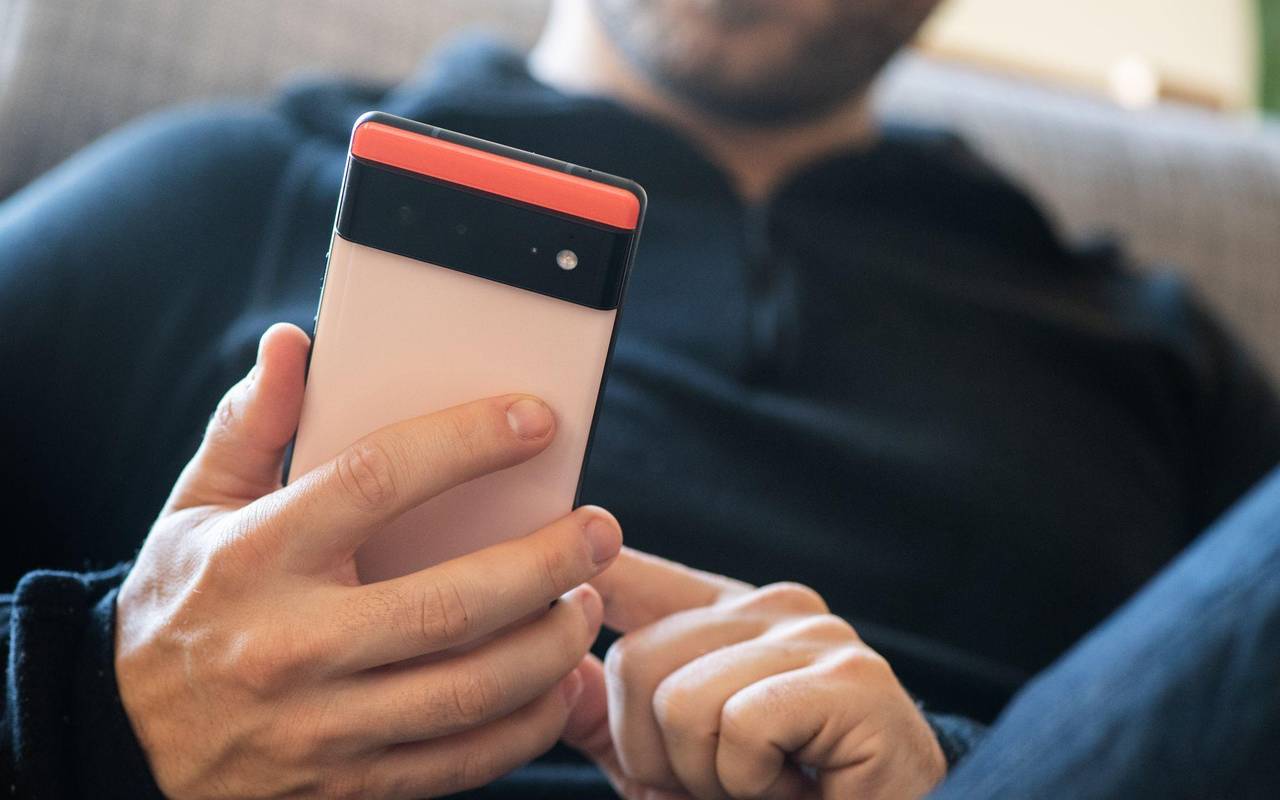Ein Mann hält ein Google Pixel 6 in den Händen