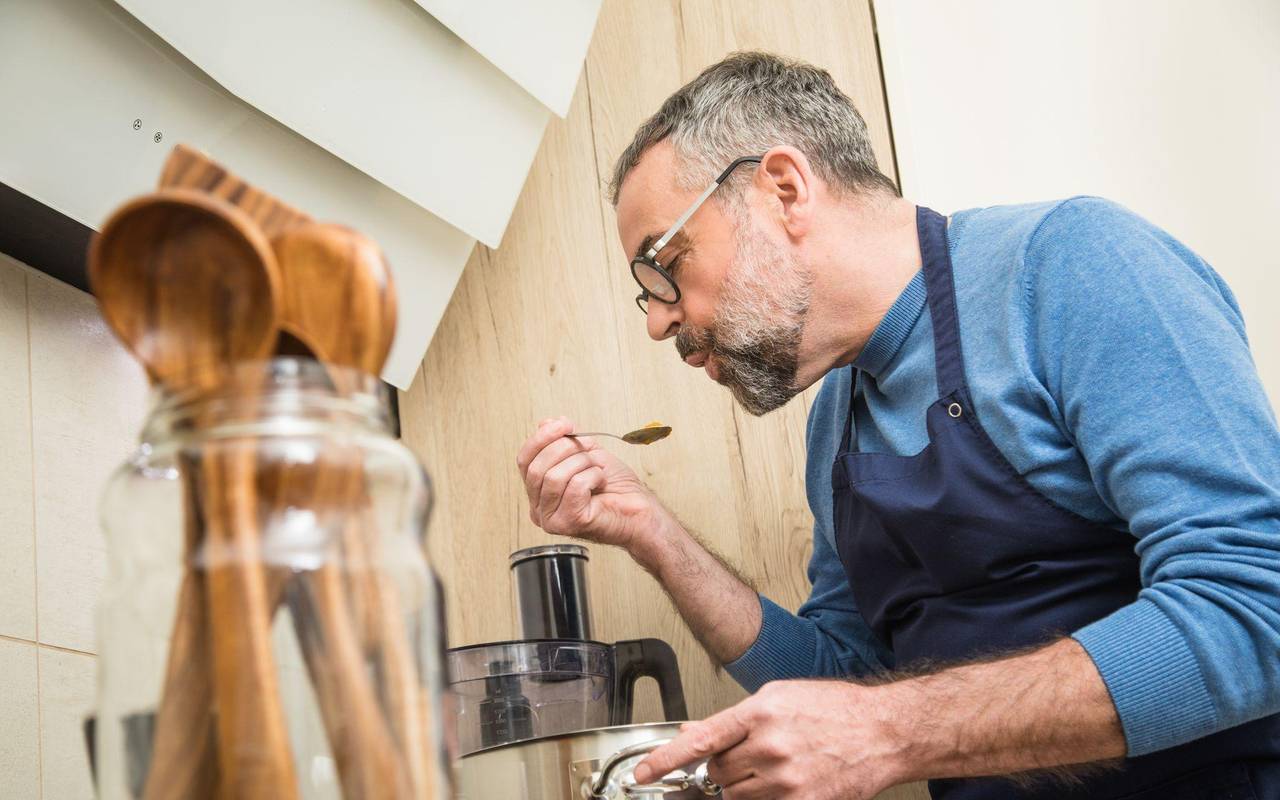 Ein Mann schmeckt ein Gericht ab