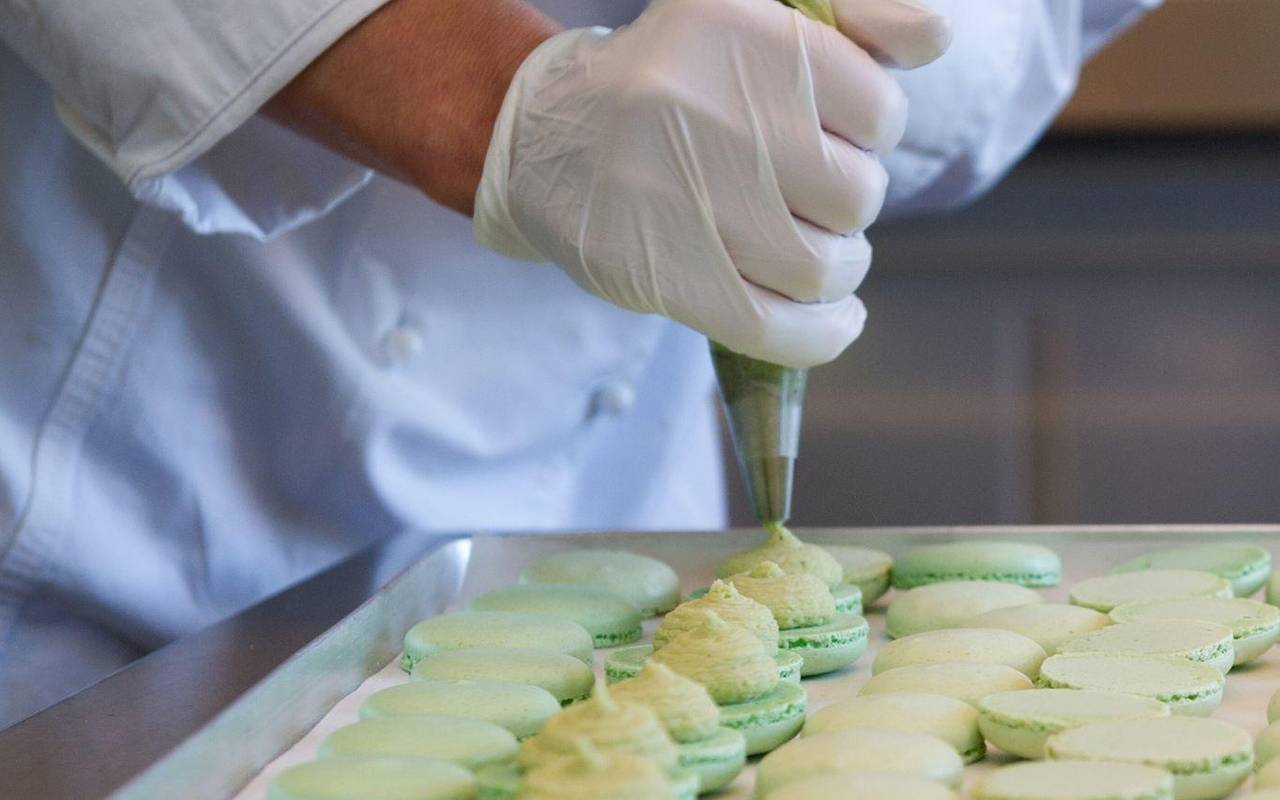 Macaronhälften werden mit einem Spritzbeutel gefüllt
