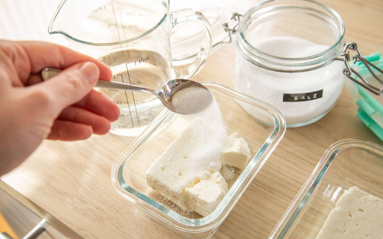 Feta in einer Schale wird gesalzen
