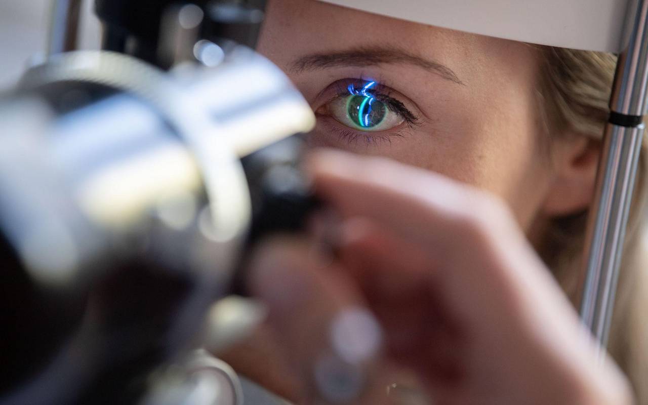 Ein Arzt untersucht das Auge einer Patientin